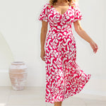 Woman stands poolside in Mica Maxi Dress from Leina & Fleur's Cherry charm collection. This maxi dress is perfect for event dressing this summer season. Made from dry touch jersey fabric to ensure you stay cool and comfortable while maintaining a polished appearance. Shop Mica Maxi Dress in sizes 8-24.