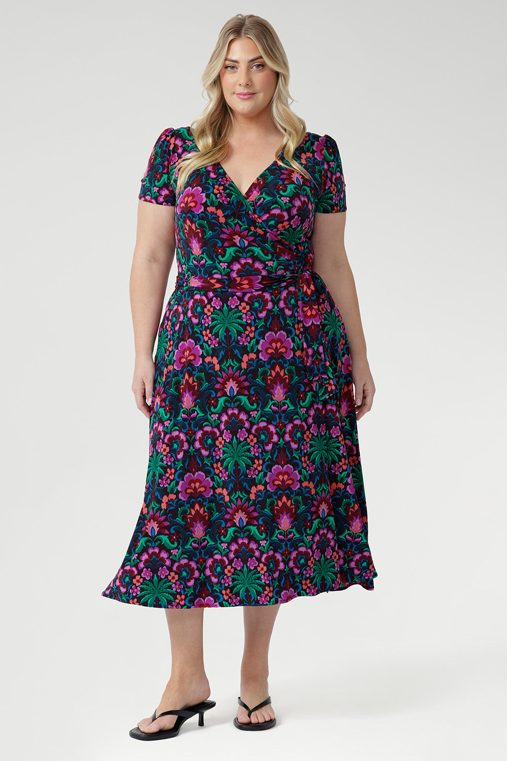 Crafted from our signature dry-touch stretch jersey, the Alexis Wrap Dress is often described as the "perfect wrap dress" by the L+F community. Designed to effortlessly transition from workwear to events and weekend outings, this flattering midi dress features a vibrant floral print in bold hues of pink, green, burgundy, and blue.