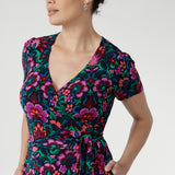 The fully functioning wrap style includes extended waist ties for a customizable fit, while the double-layer back bodice offers added comfort and structure.