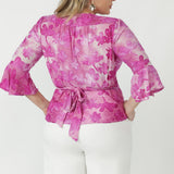 Luxe Amora peplum top crafted from soft stretch burnout fabric with gathered sleeve heads, a detailed back yoke and adjustable wrap waist ties.