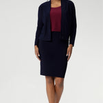 The Andi Tube Skirt is available in a mini, regular and midi length for a bold and stylish look no matter your style. Size 10 woman wears her navy tube skirt with matching jacardi in navy & ruby Top.