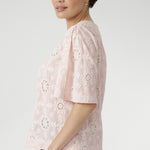  Exquisite botanical motifs and cut-out accents add artisanal charm to this breathable, easy-to-wear style. Pair with linen pants or the coordinating skirt for effortless summer elegance. 