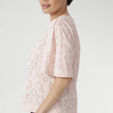  Exquisite botanical motifs and cut-out accents add artisanal charm to this breathable, easy-to-wear style. Pair with linen pants or the coordinating skirt for effortless summer elegance. 