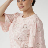Australian designed top in a relaxed silhouette with a round neckline, topstitch detailing, and flared short sleeves finished with a subtle pleat.