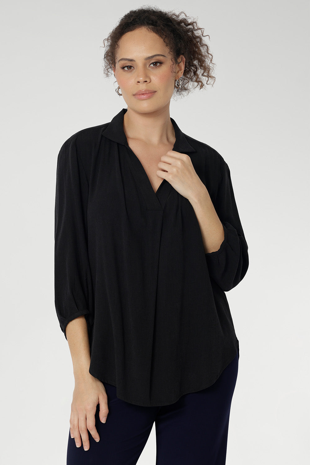 Over 30's woman wears a woven shirt with collar and tailored pleat front. Made from sustainable tencel fabric. Made in Australia for women size 8-24. 