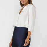 Arley Shirt in Vanilla features a buttonless design with clean lines, and a cool, contemporary look. Its versatile style makes it perfect for tucking into pants or skirts with ease.