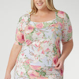 The squared scoop neckline and structured bust offer a refined, modern shape, while the short sleeves with delicate tucks at the sleeve-head add subtle detail and elegance.
