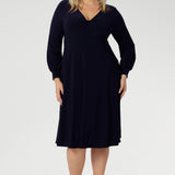 Featuring a sophisticated V-neckline with a twist-front bodice and cuffed long sleeves, it creates a flattering silhouette with elegant detail. Made in Australia from our signature dry-touch jersey fabric, it offers all-day comfort, stretch, and easy care. Available in sizes 8 to 24, this versatile piece is designed to flatter petite and plus-size women alike.