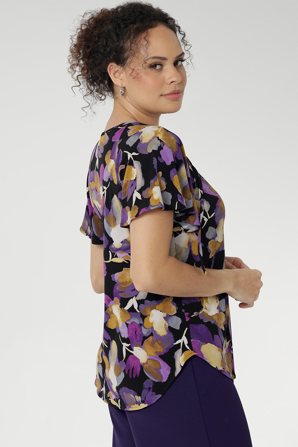 With its relaxed fit, centre-front pleat, raglan shoulders, and soft flutter sleeves, the Bowie Top drapes beautifully on the body, finished with a curved shirt-tail hemline for added movement. 