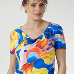 With its cowl neckline, relaxed blouson shape, and flowing asymmetrical skirt, this floral beauty is perfect for sunny days, seaside escapes, and easy weekends. Made in Australia, sizes 8–24.