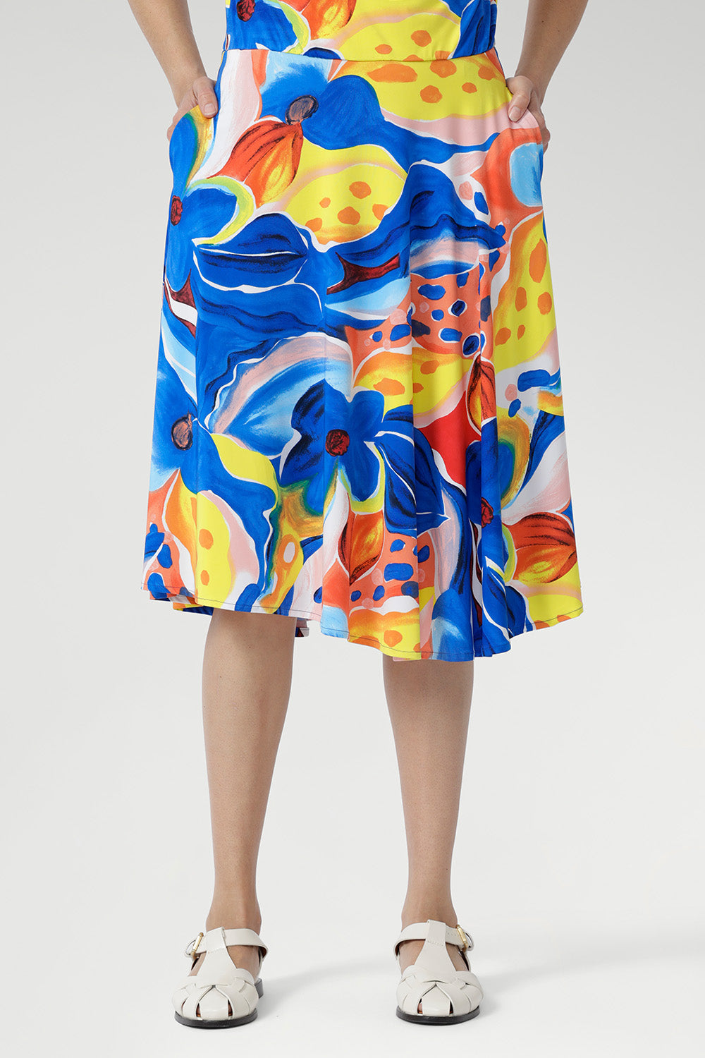 With a flattering cowl neckline, blouson bodice, and softly flowing asymmetrical skirt, it’s finished with delicate shoulder tucks and a vibrant floral print. Perfect for holidays, casual weekends, or any warm summer day. Made in Australia, sizes 8–24.