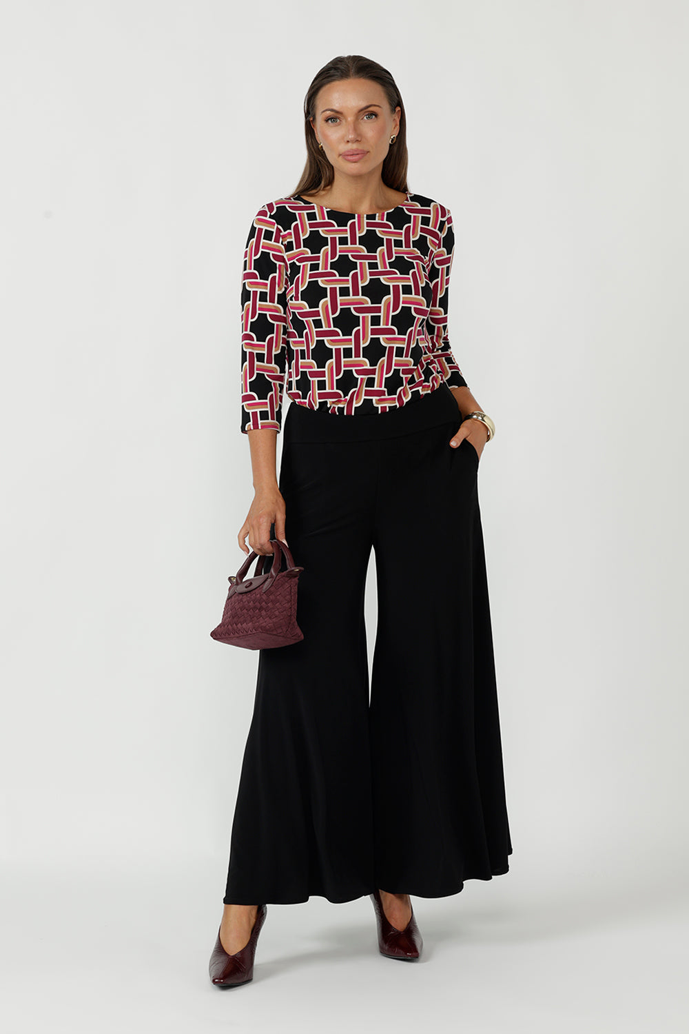 Collins Top with boat neckline and 3/4 sleeves in a bold Ruby Connection geometric print, crafted from premium dry-touch jersey with a flattering fitted silhouette.