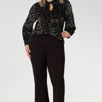 The Celine Top in Animal Burnout is a sophisticated statement piece, expertly crafted from luxurious velour fabric with a distinctive burnout effect. Designed to transition seamlessly from office wear to special events, this versatile blouse can be styled tucked in for a polished look or worn loose for effortless elegance.