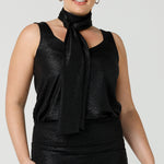 A shimmering jersey neck tie in black puts the finishing touch to a long sleeve, sparkly jersey top for an evening event look. Made in Australia by women's clothing and occasionwear brand, L&F.