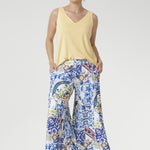 Crafted from our soft-touch stretch jersey, the Dany Culotte in Mosaic Tile captures the essence of Mediterranean elegance. Featuring an intricate Sicilian-style mosaic print in vibrant shades of cobalt, yellow, brown, and green on a crisp white base, these wide-leg culottes offer effortless movement and a beautifully fluid drape.
