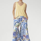 Crafted from our soft-touch stretch jersey, the Dany Culotte in Mosaic Tile captures the essence of Mediterranean elegance. Featuring an intricate Sicilian-style mosaic print in vibrant shades of cobalt, yellow, brown, and green on a crisp white base, these wide-leg culottes offer effortless movement and a beautifully fluid drape.