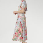 An elegant V-neck with a functional tie front, flared sleeves with subtle slits, and softly gathered detailing add feminine charm and graceful flow.