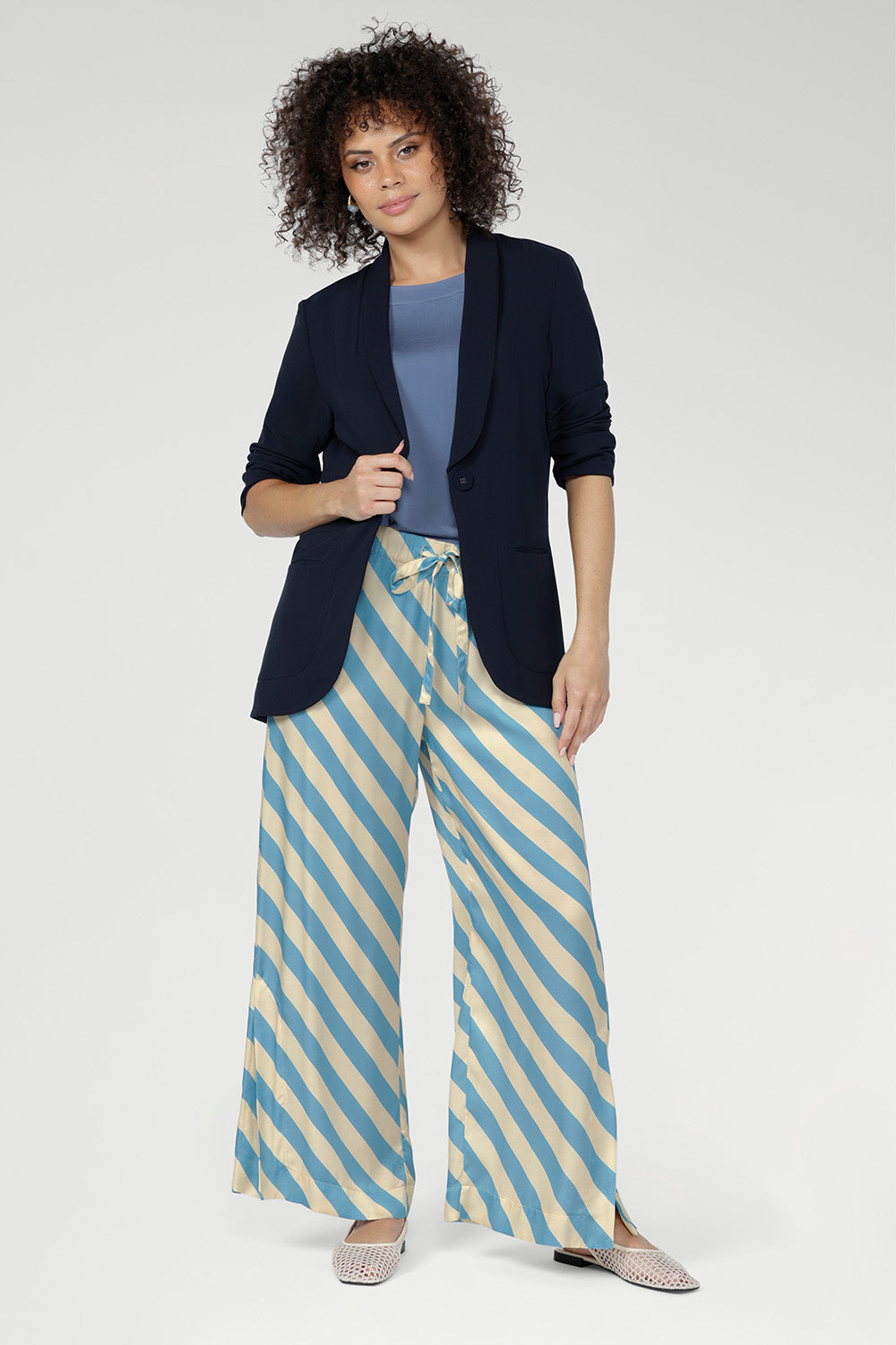 Functional side pockets add everyday practicality, while subtle hem slits enhance movement and flow. Pair back with Merit Blazer for a polished look