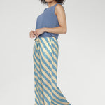 Finished in the Blue Sky Stripe, a fresh diagonal blend of sky blue and vanilla tones, these pants pair perfectly with simple tees or matching tops for a cohesive look.