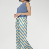 Finished in the Blue Sky Stripe, a fresh diagonal blend of sky blue and vanilla tones, these pants pair perfectly with simple tees or matching tops for a cohesive look.