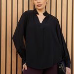 A size 10 woman wears the Ellis shirt made from Australian made graphite tencel fabric. With cuff detail and collared neckline. Made in Australia for women size 8-24.