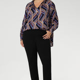 A structured collar frames the neckline, leading into a soft V-neckline with a tailored tuck at the centre, adding subtle shaping to the relaxed design. Thoughtful tuck details at the back enhance the swing silhouette, offering both style and structure. 