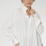 A size 10 woman wears the Ellis shirt in Vanilla tencel, a high quality made in Australia womens shirt made in breathable tencel. Inclusive size range 8-24 and made in Australia. Styled back with Black Tube Skirt 