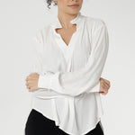 A size 10 woman wears the Ellis shirt in Vanilla tencel, a high quality made in Australia womens shirt made in breathable tencel. Inclusive size range 8-24 and made in Australia. Styled back with Black Tube Skirt 