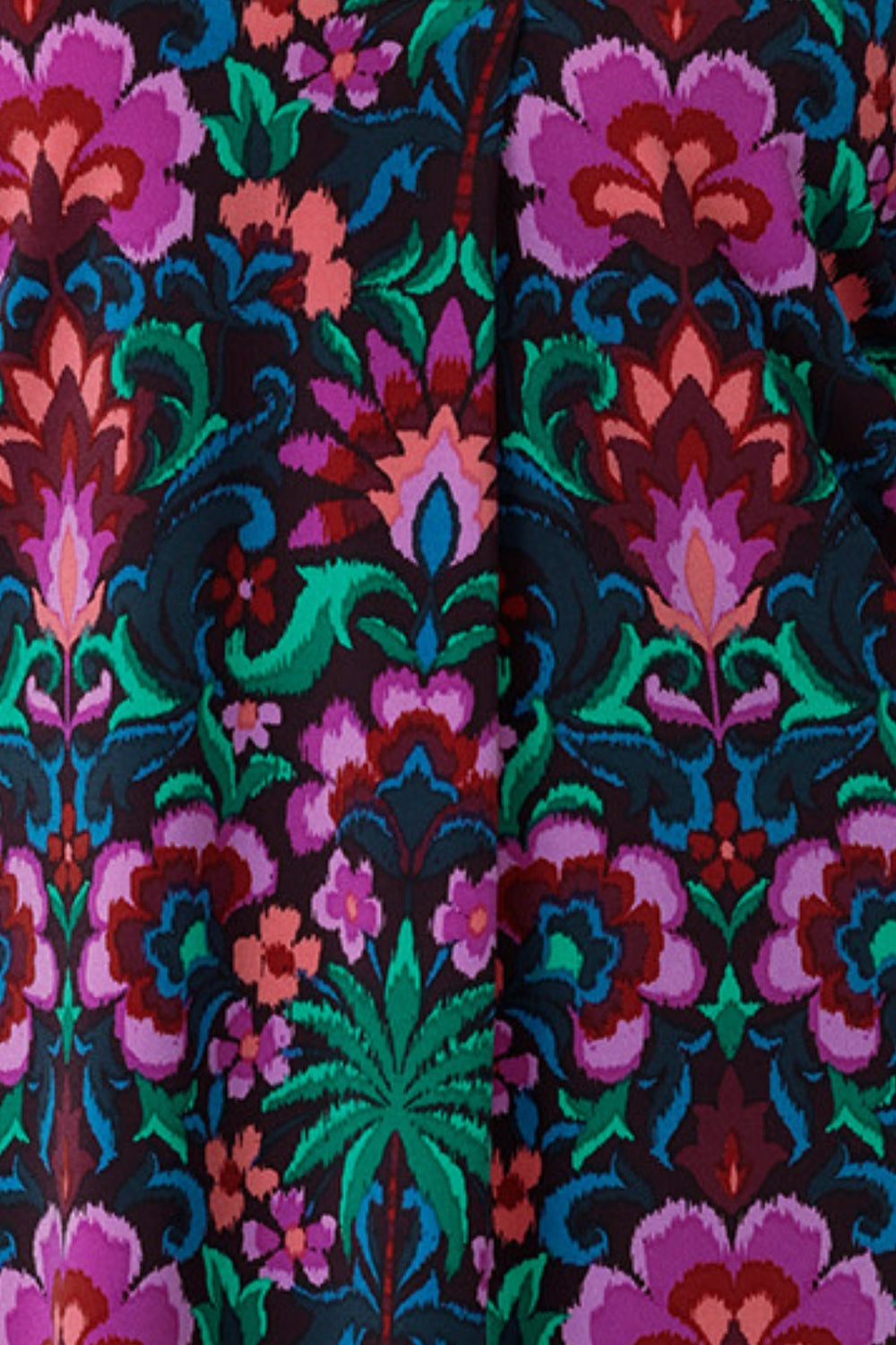 This vibrant printed fabric, featuring bold hues of pink, green, burgundy, and blue, is used to create a stunning collection of women’s spring fashion, including a maxi wrap dress, culotte pants, and a flutter sleeve top. Proudly made in Australia and available in sizes 8 to 24.