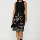 Gilded Noir Shift Dress crafted from a luxe winter-weight jacquard knit with firm stretch, featuring a textured black base with elegant toffee and cream print detailing for timeless sophistication.