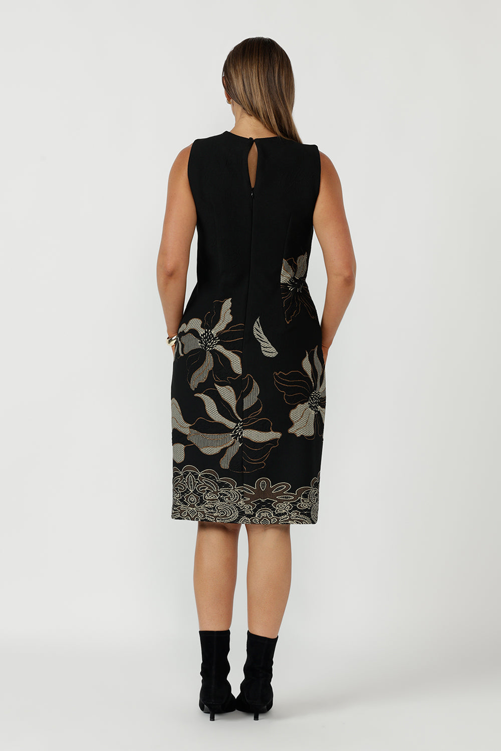 Elegant sleeveless shift dress from the Gilded Noir Collection, crafted from winter-weight jacquard knit with a flattering tailored fit, keyhole back detail and invisible zip closure.