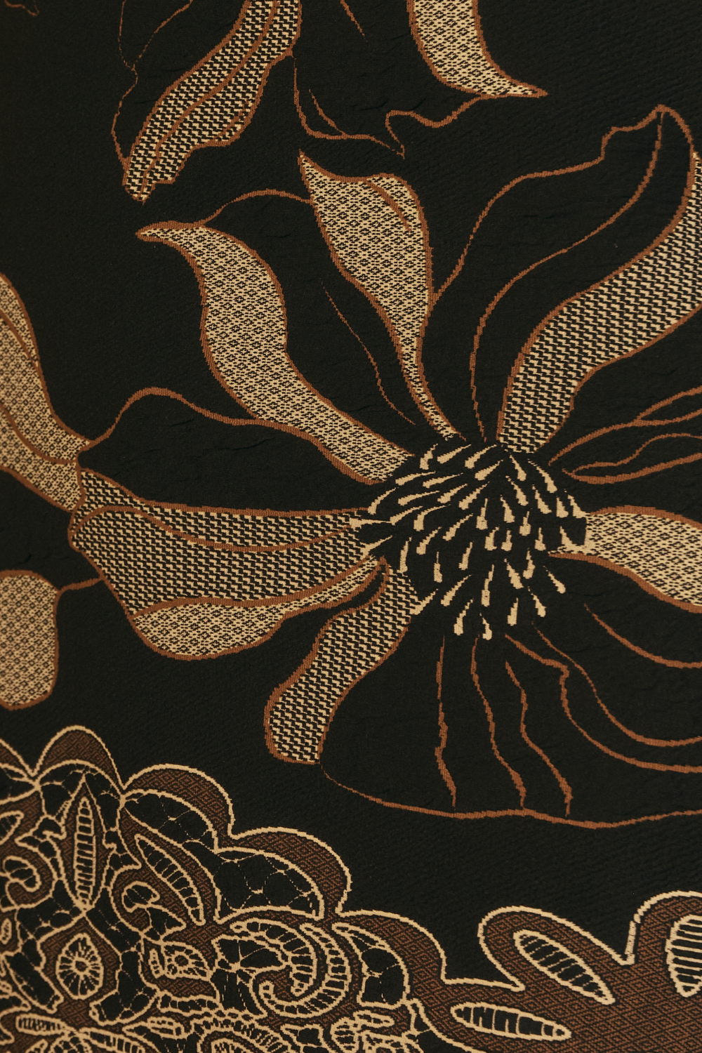 Close-up image swatch of a floral pattern with gold, toffee and cream embroidery on black textured knit fabric. Used to craft the women's winter collection, Gilded Noir by Fleur Collective in sizes 8-24.