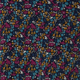 Close up swatch image of Harmony print, which features a navy dry-touch jersey base adorned with floral details in rich hues of magenta, mustard, blue, and vanilla. Used to create garments for a summer corporate wardrobe in sizes 8-24.