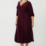 Australian-made Helena Dress designed with a sophisticated wrap-style bodice, flowing ruffle hem and comfortable stretch jersey fabrication for effortless occasion dressing.