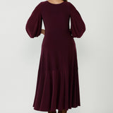 Timeless Helena Dress featuring a flowing maxi silhouette, ruffle hem detailing, side pockets and premium Australian-made stretch jersey construction.