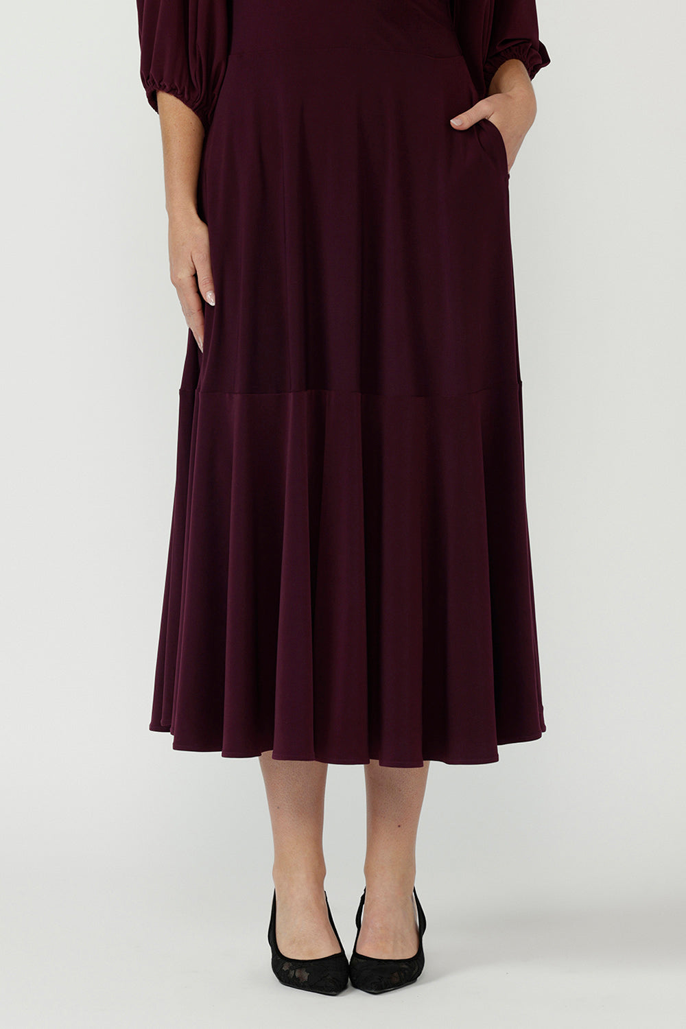 Helena Wrap Dress in premium stretch jersey with a feminine maxi silhouette, cascading ruffle hem and statement sleeves for elevated day-to-night style.