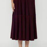 Helena Wrap Dress in premium stretch jersey with a feminine maxi silhouette, cascading ruffle hem and statement sleeves for elevated day-to-night style.