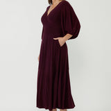 Sophisticated Helena Dress showcasing a fixed wrap bodice, flowing full-length skirt and soft stretch jersey fabrication for comfort and effortless glamour.