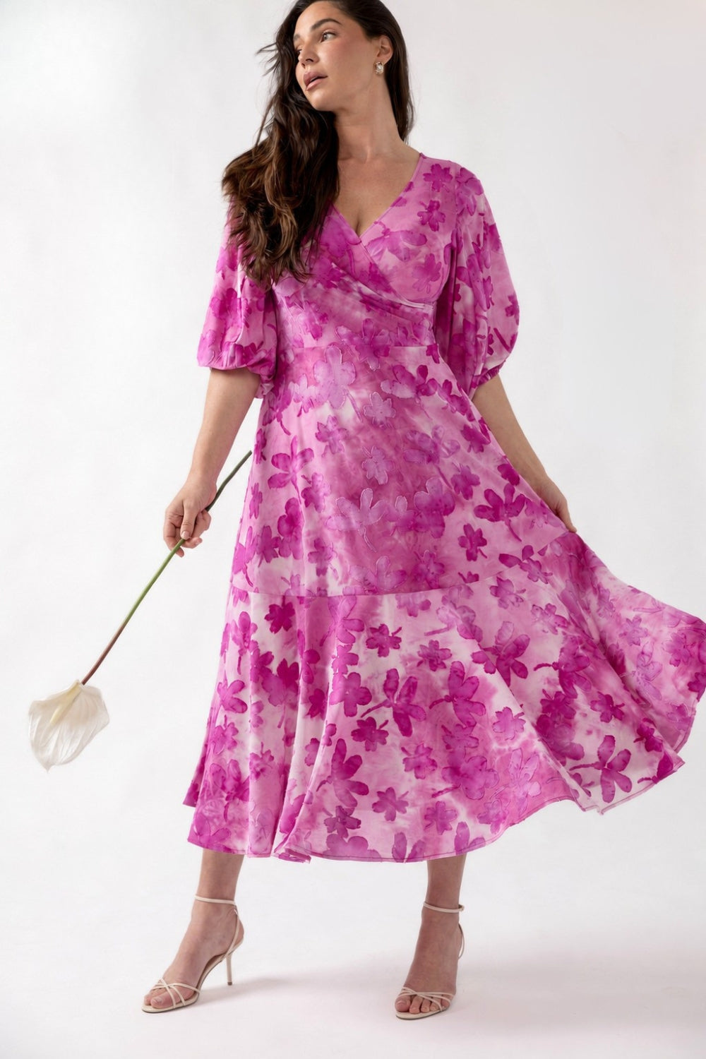 Helena Dress crafted from luxe textured burnout fabric with soft stretch, featuring a flattering fixed wrap V-neckline, lantern sleeves and flowing ruffle hem.