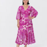 Elegant Helena Dress with a fixed wrap V-neckline, statement lantern sleeves and feminine ruffle hem, available in Regular and Petite fits in sizes 8–24.