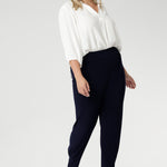 These chic 7/8 length pants feature single inside seam legs, a tapered fit, and ankle cuffs with a tuck detail, offering a sleek, modern silhouette. The Indi is the ultimate travel pant, so comfortable that you’ll want more than one pair. Perfectly versatile, it pairs effortlessly with our blazers for a seamless transition from weekend to work. Available in two different heights, designed for both plus-size and petite women.