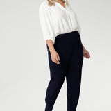 These chic 7/8 length pants feature single inside seam legs, a tapered fit, and ankle cuffs with a tuck detail, offering a sleek, modern silhouette. The Indi is the ultimate travel pant, so comfortable that you’ll want more than one pair. Perfectly versatile, it pairs effortlessly with our blazers for a seamless transition from weekend to work. Available in two different heights, designed for both plus-size and petite women.