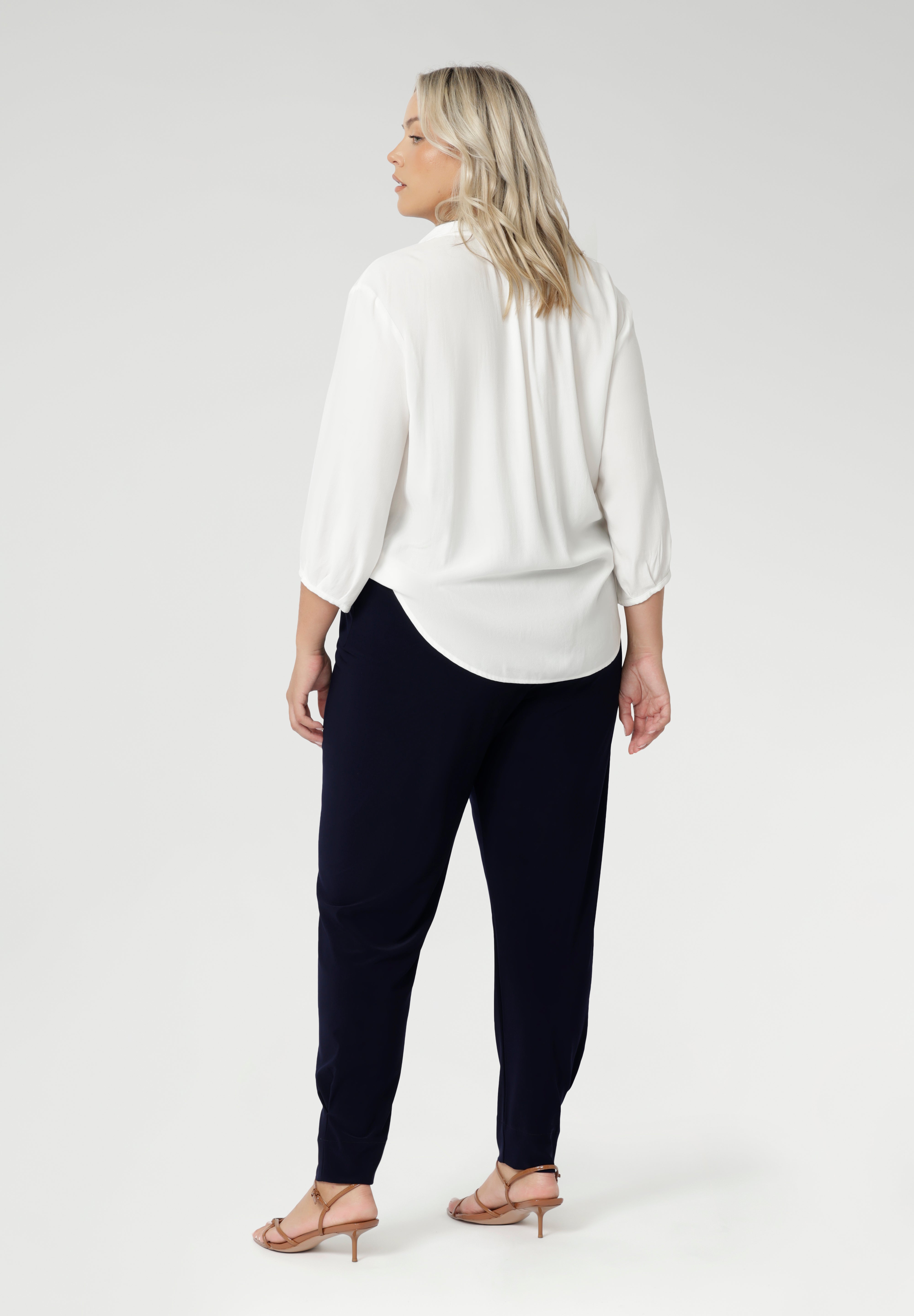 These chic 7/8 length pants feature single inside seam legs, a tapered fit, and ankle cuffs with a tuck detail, offering a sleek, modern silhouette. The Indi is the ultimate travel pant, so comfortable that you’ll want more than one pair. Perfectly versatile, it pairs effortlessly with our blazers for a seamless transition from weekend to work. Available in two different heights, designed for both plus-size and petite women.