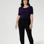 Petite height model wears  travel pant that feature dropped crotch & tapered legs. Model is size 10. Travel ready pants made from stretchy jersey for ultimate comfort. Made for Australian and New Zealand women, by clothing brand Leina & Fleur. Now available in sizes 8-24 and in 2 lengths.