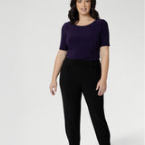 Petite height model wears  travel pant that feature dropped crotch & tapered legs. Model is size 10. Travel ready pants made from stretchy jersey for ultimate comfort. Made for Australian and New Zealand women, by clothing brand Leina & Fleur. Now available in sizes 8-24 and in 2 lengths.