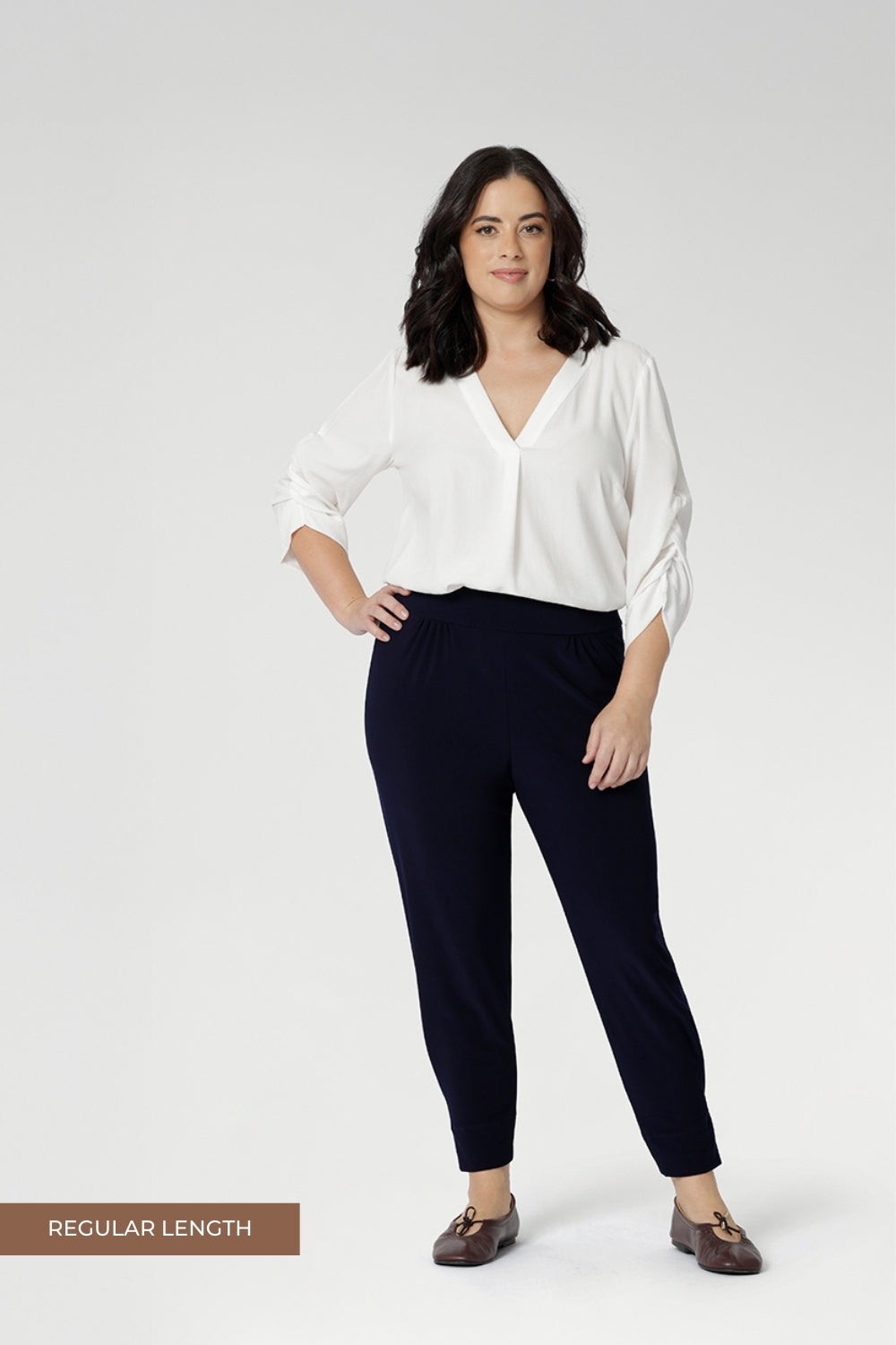 Petite height model wears  travel pant that feature dropped crotch & tapered legs. Model is size 10. Travel ready pants made from stretchy jersey for ultimate comfort. Made for Australian and New Zealand women, by clothing brand Leina & Fleur. Now available in sizes 8-24 and in 2 lengths.