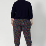 Tapped leg pant seen on plus sized model paired with navy jacket. These pants are versatile enough to be dressed up or down, making them a must-have for travel, work, or casual outings. Whether you're on the go or looking for a chic and comfy addition to your wardrobe. Available in 8-24.