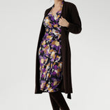 The vibrant painterly-style floral print, rich in purples and soft yellow hues, adds an artistic touch to a timeless silhouette. With its functioning wrap design, extended waist ties, and angular interlined collar, the Jett Dress brings a contemporary edge to your workwear wardrobe