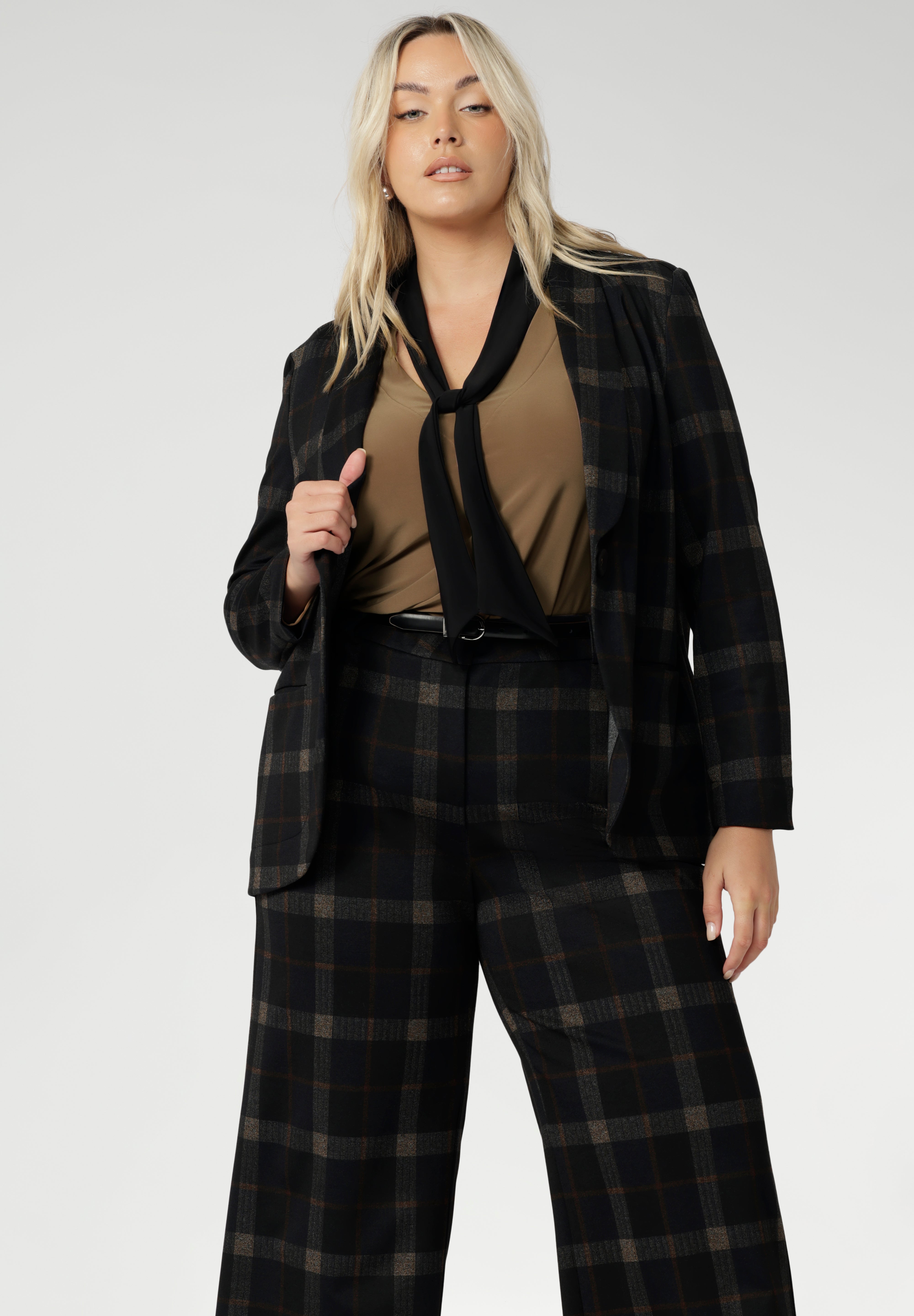 The full collection includes three core pieces: the Kade wide leg pant, the Lulu tapered pant, and a sharp, coordinating blazer that ties the look together. Available in inclusive sizes 8 to 24, this is suiting designed for women who dress with confidence, ease, and intention. Shop the Cocoa Plaid collection online at Leina + Fleur.