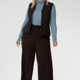Made from a blend of stretchy Tencel wool fabric, it offers both flexibility and coziness, making it the perfect layering piece for cooler weather. Size 18 model wears her turtle neck top under her soft suiting, pairing her Pennyworth vest over the tencel wool top.